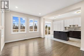 Ottawa apartment for rent - A spacious kitchen with white cabinets and a black island.