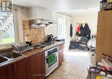 Markham (Thornlea) apartment for rent - A kitchen with a stove top oven and a sink.