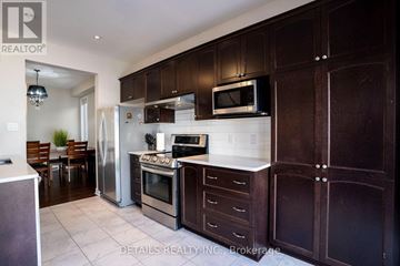 Ottawa apartment for rent - A kitchen with dark brown cabinets and stainless steel appliances.