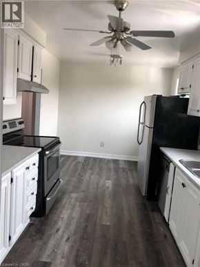 Hamilton apartment for rent - A kitchen with black appliances and white cabinets.