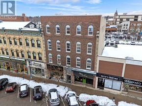 Stratford multi-family for rent - A parking lot with cars and a building with a sign that says "Blown Away".