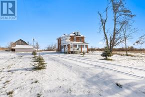Kawartha Lakes (Verulam) apartment for rent - A large house with a snow-covered yard in front of it.