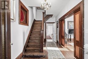 Kawartha Lakes (Verulam) apartment for rent - A wooden staircase leads up to a landing with a chandelier.