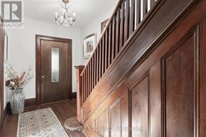Kawartha Lakes (Verulam) apartment for rent - A wooden staircase with a chandelier above it.