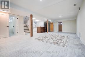 Toronto (Banbury-Don Mills) apartment for rent - A spacious room with a staircase and a rug in the center.
