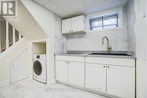 Toronto (Banbury-Don Mills) apartment for rent - A white kitchen with a washer and dryer built in.