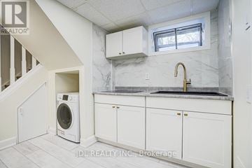 Toronto (Banbury-Don Mills) apartment for rent - A white kitchen with a washer and dryer built in.