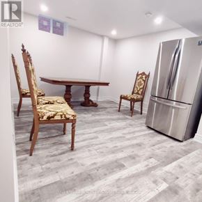 Vaughan (Brownridge) apartment for rent - A dining room with a wooden table and chairs.