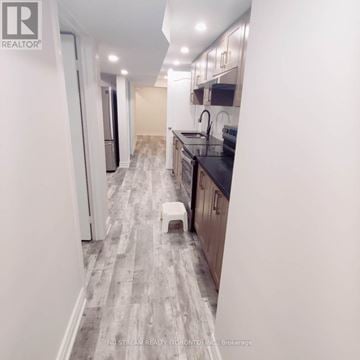 Vaughan (Brownridge) apartment for rent - A kitchen with a black counter top and a white stool.