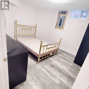 Vaughan (Brownridge) apartment for rent - A bedroom with a bed, dresser, and a mirror on the wall.