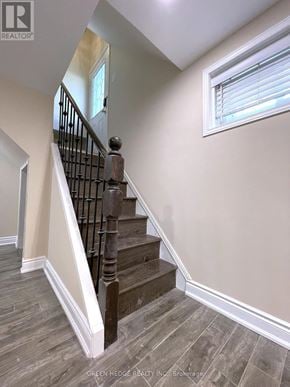 Toronto (Willowridge-Martingrove-Richview) apartment for rent - A staircase with a wooden handrail and a window.