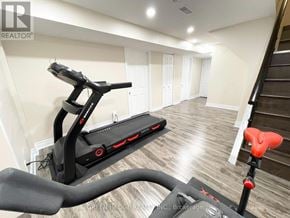 Toronto (Willowridge-Martingrove-Richview) apartment for rent - A treadmill in a room with a brokerage logo on the wall.