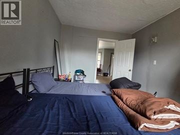 Windsor apartment for rent - A bedroom with a bed, pillows, and a blanket.