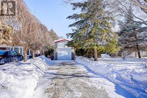 Toronto (Banbury-Don Mills) apartment for rent - A snow-covered driveway leads to a white garage with a red roof.