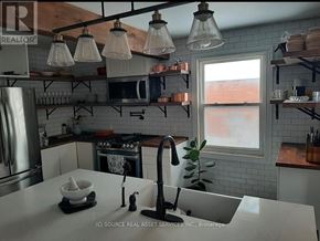 Hamilton (Dundas) apartment for rent - A kitchen with a white counter top and a window.