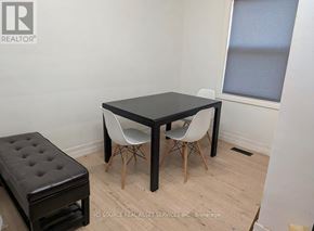 Hamilton (Dundas) apartment for rent - A black table with two white chairs and a black ottoman in a room.