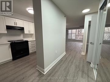 Toronto (Englemount-Lawrence) condo for rent - A kitchen area with a stove top oven and cabinets.