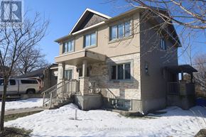 Ottawa apartment for rent - A two-story house with a garage and a car parked in front.