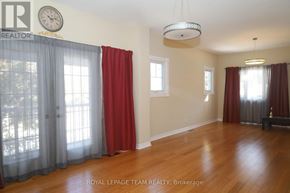 Ottawa apartment for rent - A room with wooden floors and red curtains.