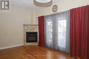 Ottawa apartment for rent - A living room with a fireplace and a clock on the wall.