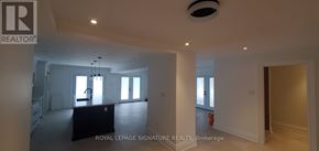 Toronto (Highland Creek) apartment for rent - A large, empty room with a staircase on the left and a fire extinguisher on the right.