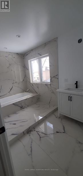 Toronto (Highland Creek) apartment for rent - A bathroom with marble flooring and white walls.