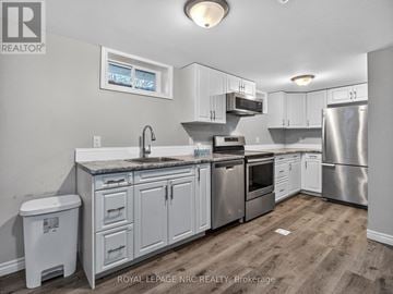 Welland (N. Welland) duplex for rent - A kitchen with white cabinets and stainless steel appliances.