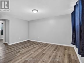 Welland (N. Welland) duplex for rent - A room with wooden flooring and white walls.