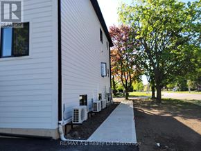 Stratford multi-family for rent - A bathroom with a toilet, sink, and mirror.
