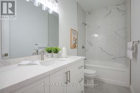 Stratford multi-family for rent - A bathroom with a marble wall and a white sink.