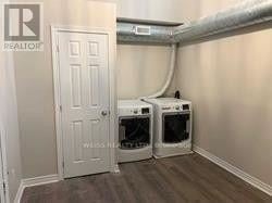 Toronto (Yorkdale-Glen Park) apartment for rent - A room with a white door and two white ovens under a pipe.