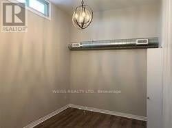 Toronto (Yorkdale-Glen Park) apartment for rent - A room with a wooden floor and a light fixture on the wall.