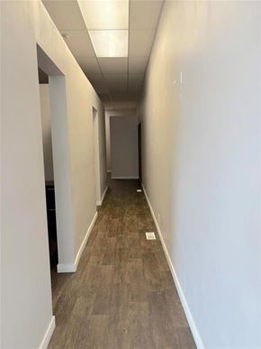 Carman apartment for rent - A long, narrow hallway with wood flooring and white walls.