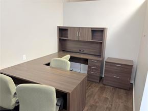 Carman apartment for rent - A brown desk with two chairs and a filing cabinet.