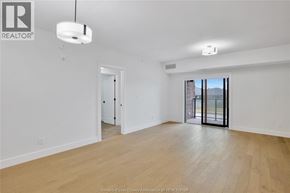 Lasalle condo for rent - A spacious room with wooden floors and white walls.