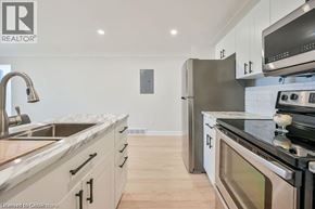 Hamilton apartment for rent - A modern kitchen with stainless steel appliances and wooden flooring.