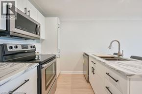 Hamilton apartment for rent - A kitchen with a stove, oven, and sink.