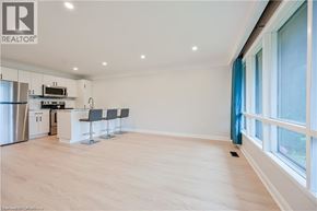 Hamilton apartment for rent - A spacious kitchen with a refrigerator, stove, and sink.