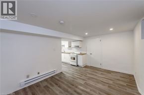 Hamilton apartment for rent - A well-lit kitchen with wooden floors and white walls.