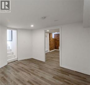 Hamilton apartment for rent - A room with wooden flooring and white walls.