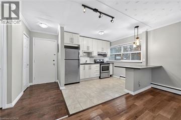 Hamilton apartment for rent - A well-lit kitchen with white cabinets and a wooden floor.