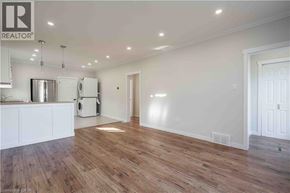 Hamilton apartment for rent - A large empty room with wooden floors and white walls.