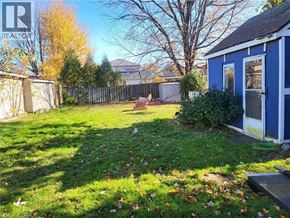 Port Colborne apartment for rent - A backyard with a blue shed and a fence.