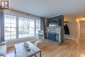 Ottawa duplex for rent - A living room with a fireplace and a couch.