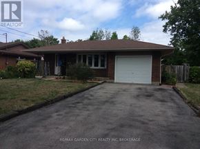 St. Catharines (Secord Woods) apartment for rent - A house with a brown roof and a white garage door.
