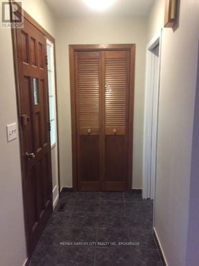 St. Catharines (Secord Woods) apartment for rent - A hallway with a wooden door and a white door.