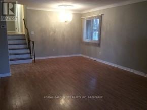 St. Catharines (Secord Woods) apartment for rent - A room with wooden flooring and a window with blinds.