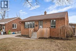 Windsor apartment for rent - A brick house with a brown roof and a wooden fence.