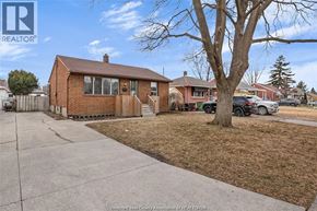Windsor apartment for rent - A house with a brown roof and a tree in front of it.