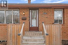 Windsor apartment for rent - A house with a brown door and a brick wall.